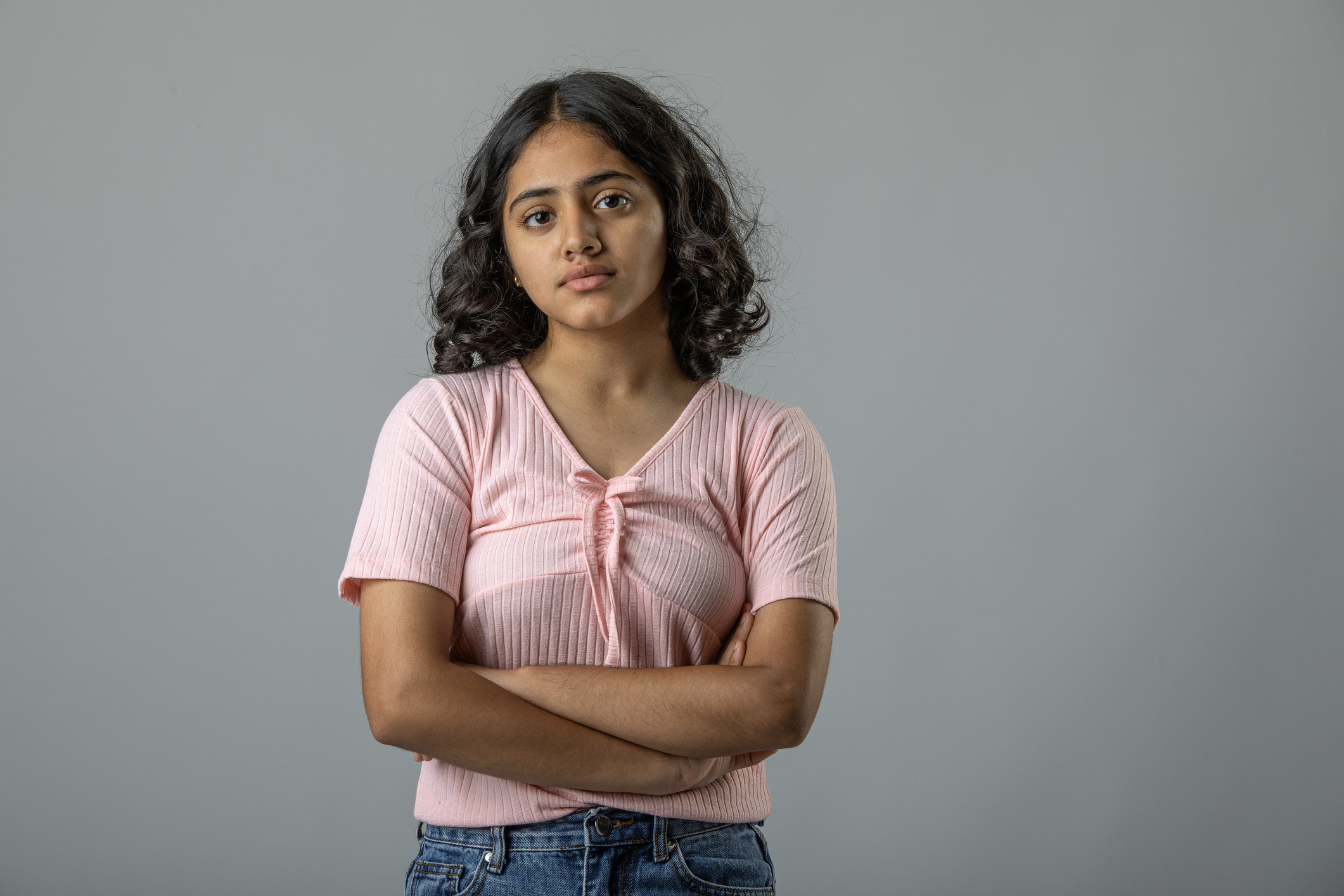 A teenage girl with crossing her arms