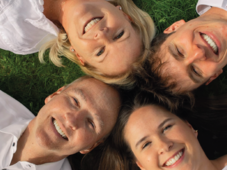A ground shot of Shawn Omstead and 3 family members smiling
