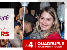 An image of Alysssa smiling while holding up a white lantern with a group of people. Overlayed with the text: "Make a difference where it truly matters. 4x Quadruple your impact today!"